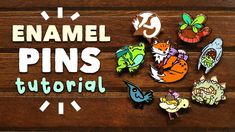 the words enamel pins are displayed on a wooden surface with various cartoon characters around it