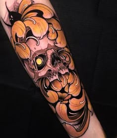 a man's arm with an orange and black tattoo design on the left forearm