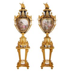 two golden vases with paintings on them