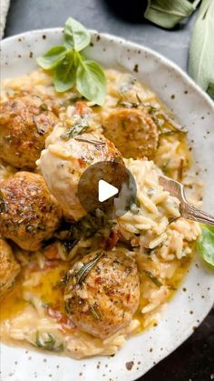 a white plate topped with meatballs and pasta