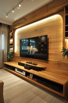 a living room with wood paneling and a flat screen tv mounted on the wall