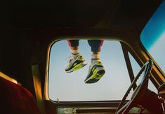 a pair of feet hanging out the window of a car