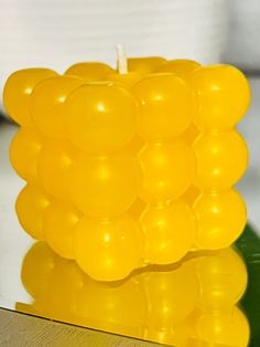 a yellow candle sitting on top of a table