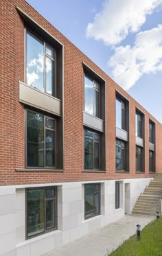 a brick building with several windows and steps leading up to it