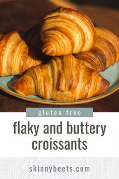 flaky and buttery croissants on a plate with text overlay reading gluten free flaky and buttery croissants