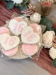 decorated heart shaped cookies sitting on top of a table