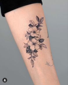 a woman's arm with flowers on it