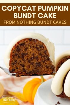 a close up of a bundt cake on a plate with a fork and pumpkins in the background