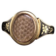 Beautiful Antique Victorian 18K Yellow Gold Enamel Hair Mourning Ring. This amazing ring has pristine enameling and the hair is still intact inside the glass. It has flower designs on the side of the ring without any damage which is rare. The inside of the ring is hallmarked. Item #R0926 Metal: 18K Yellow Gold. Weight: 4 Grams Ring Size: 8 Measurements: Top measures 13 mm wide and band measures 2.8 mm wide. Measurement from finger to top of ring: 3.75 mm Layaway: For your convenience, we will be Luxury Antique Engraved Enamel Ring, Heirloom Oval Engraved Enamel Ring, Heirloom Engraved Oval Enamel Ring, Antique Engraved Yellow Gold Enamel Ring, Antique Yellow Gold Signet Ring With Black Enamel, Antique Engraved Enamel Ring For Formal Occasions, Victorian Hallmarked Oval Enamel Ring, Victorian Oval Hallmarked Enamel Ring, Antique Enamel Rings For Formal Occasions