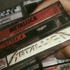 several cassettes are stacked on top of each other in the palm of someone's hand