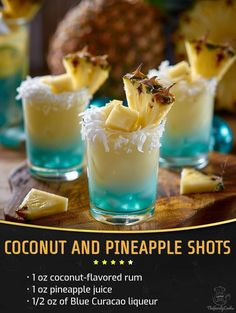 there are pineapple shots with coconut on the rim and garnishes in them