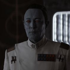 a man with red eyes in a star wars uniform