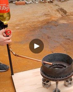 a person is pouring wine into a bucket