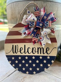 a welcome sign with stars and stripes on it