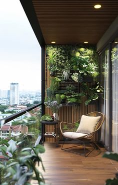 a balcony with plants on the wall and a chair in the foreground, along with a city view