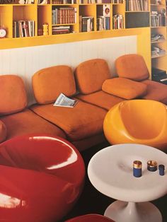 a living room filled with lots of furniture and bookshelves in it's walls