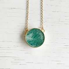 With its vibrant blue-green hue and classic gold chain, this Amazonite necklace will elevate any outfit. GEMSTONE: AmazoniteSIZE: 0.75" longCHAIN: 18" long 14k gold filledCLOSURE: Lobster clasp Stone Circle, Amazonite Necklace, Amazonite Stone, Turquoise Earrings Dangle, Circle Pendant Necklace, Classic Gold, Vibrant Blue, Gems Jewelry, Circle Pendant