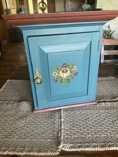 a blue cabinet sitting on top of a rug