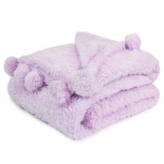 a purple teddy bear blanket folded on top of each other