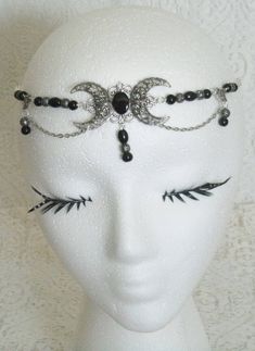 "This beautiful circlet has black Czech glass beads, black pearl beads, sterling silver plated filigree beads, sterling silver plated accents, sterling silver plated chain and sterling silver plated crescent moon pendant with black onyx setting. An elegant headpiece. 20\" long can be adjusted to 24\". Lobster clasp." Silver Beaded Metal Body Jewelry, Elegant Silver Beaded Headpiece, Silver Adjustable Headband For Festivals, Adjustable Black Costume Jewelry, Adjustable Black Jewelry For Costume, Elegant Beaded Halloween Jewelry, Elegant Beaded Jewelry For Halloween, Handmade Black Bohemian Body Jewelry, Handmade Black Body Jewelry For Festival