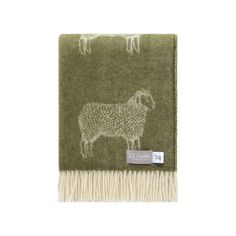 a green blanket with sheep on it