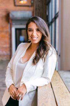 a woman is sitting on a bench smiling