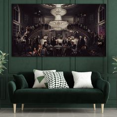 a living room with green walls and a painting on the wall that has people gathered around it