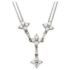 This delicate double chain diamond drop necklace is absolutely stunning. Featuring round and baguette shaped glittering natural diamonds and solid 14 karat white gold, this stunning piece offers femineity and elegance in a timeless style. The double chain design gives it a more contemporary look, while the drop of dazzling diamond clusters really pop on the neck. You will adore this piece! Necklace type: Drop Metal: 14 Karat White Gold Natural Diamond: 1.19 carats Diamond cuts: Round Brilliant and Tapered Baguette Diamond color: G-H Diamond clarity range: VS1-SI2 Drop length: 30 mm Chain length: 17" Individual Chain width: .68 mm Weight: 5.0 grams Stamped: 14K GC Estate Condition: Very good, professionally cleaned and polished. Some very minor wear on the clasp. Appraisal Value: $3,200.00 Gold Drop Necklace, Diamond Drop Necklace, Chain Diamond, Drop Pendant Necklace, White Gold Chains, Circle Diamond, Double Chain, Diamond Drops, Bezel Diamond