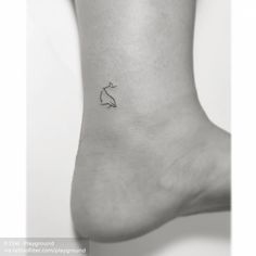 a small tattoo on the ankle of a woman's foot, with a cat