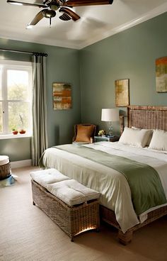 a bedroom with green walls and white bedding, two wicker baskets on either side of the bed