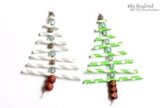 two green and white christmas trees made out of paper straws with candy sticks attached to them