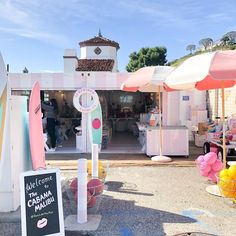 an open air market with umbrellas and other items