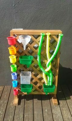 a wooden rack with plastic cups and hoses attached to it