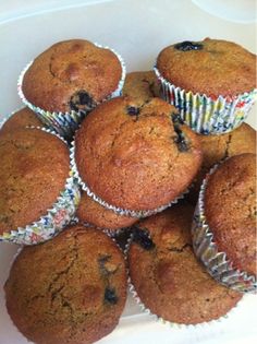 a pile of muffins sitting on top of a white plate covered in blueberries