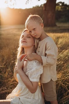 a woman holding a boy in her arms