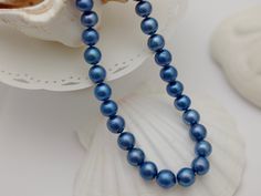 Material        : Genuine Natural Freshwater Pearls Quantity       : One Necklace Length         :  Please choose the length from the menu option Color            :  Royal Blue Baroque Pearls as pictured (color is dyed) Bead Shape : Irregular Baroque Pearls as pictured Bead Size       10-12 mm approx. Clasp  Size  :  14mm Spring Clasp Lead Time & Shipping :  This is an order to make item.  We will ship your order in 2-3 business day once order received.  If we offer FREE DOMESTIC shipping, package will be shipped via USPS First Class mail on orders shipping within the U.S.. Remarks : **This item is a custom order with length of your choice - this is non-returnable and non-exchangeable item once purchased**  D I S C O U N T   C O U P O N S :- Use coupon code :  SPECIAL10  ---->  10% Discoun Elegant Blue Pearl Necklace For Formal Occasions, Blue Single Strand Round Pearl Necklace, Blue Single Strand Pearl Necklace, Classic Blue Pearl Necklace For Gift, Blue Single Strand Pearl Necklace For Formal Occasions, Formal Blue Single Strand Pearl Necklace, Elegant Blue Round Pearl Necklace, Baroque Pearl Necklace, Baroque Pearls