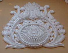 a white decorative piece on the wall