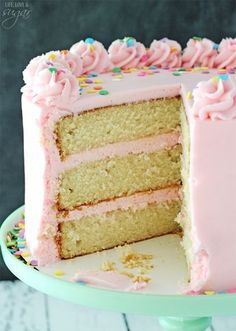 a cake with pink frosting and sprinkles