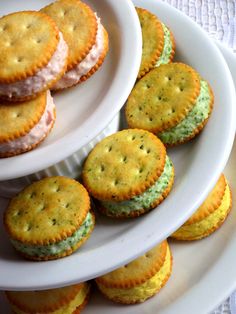 there are many small crackers on the white plate and one is filled with them