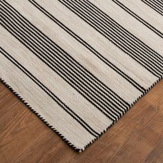 black and white striped rug on wooden floor