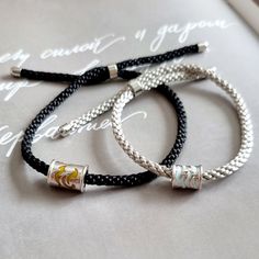 Shop our handmade minimalist braided rope couple bracelets. It can be used as personalized gift for couples, lovers, best friends, sisters or long-distance relationship. Fully adjustable rope with 925 sterling silver material makes bracelet very comfortable to wear. Mentioned price is for a pair of bracelets i.e. 1 men bracelet and 1 women's bracelet. -------- ITEM DETAILS -------- Material: 18k gold plated 925 sterling silver + high quality rope ---------- HOW TO ORDER ---------- - Please place an order first and then via Conversations please provide us engraving text in below mentioned format:  Men Bracelet Engraving on Front:  Women Bracelet Engraving on Front:  Men Bracelet Engraving on Back:  Women Bracelet Engraving Back:  - After placing an order please make sure to check Conversati Handmade Sterling Silver Braided Friendship Bracelets, Personalized Silver Braided Bracelets For Friendship, Sterling Silver Friendship Bracelet With Sliding Knot, Silver Braided Jewelry For Friendship, Personalized Silver Braided Bracelet Minimalist Style, Personalized Silver Braided Minimalist Bracelet, Minimalist Silver Braided Bracelet With Sliding Knot, Silver Minimalist Braided Bracelet With Sliding Knot, Everyday Silver Braided Bracelet With Sliding Knot