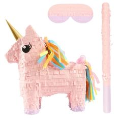 a pink pinata with a unicorn on it next to a stick and some decorations