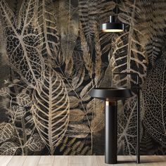 an artistic wallpaper with leaves on it and a floor lamp in front of it