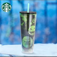 a starbucks cup with a green and black design on it