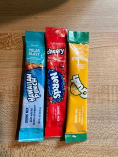 three bars of candy sitting on top of a wooden table