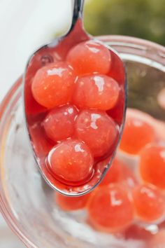 a spoon filled with jelly beans on top of a table