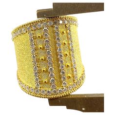 You are admiring S.Georgios designer 18 Karat Solid Yellow Gold Wide Ring all handmade in Byzantine style and a stunning unique velvet background. This gorgeous ring features 1.08 Carats of Brilliant-cut White Diamonds around the edges and in intricate lines. This ring is a beautiful combination of the byzantine technique and a very modern design. This look can be also ordered in all White, or Rose Gold, please contact us. The ring is outstanding in the quality of workmanship and stone collectio Velvet Background, Gorgeous Ring, Wide Ring, Wide Rings, Stone Collection, Athens Greece, White Diamonds, Solid Yellow, Cocktail Rings