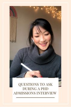 a woman holding a pen and smiling with the words questions to ask during a phd interview