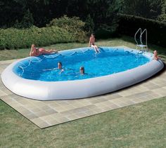 an inflatable swimming pool with people playing around it