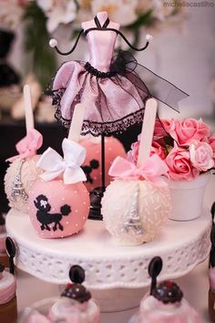 a cake decorated with pink and white decorations